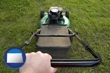 using a power lawn mower to maintain the appearance of a lawn - with North Dakota icon